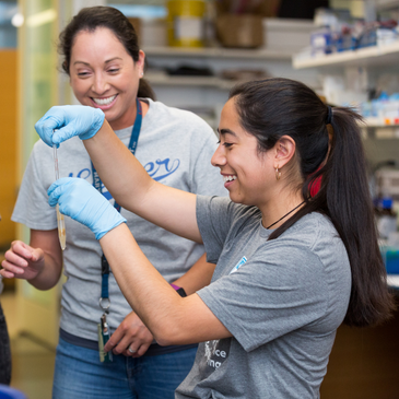 Dr Vasquez does research on LMU's campus with a student